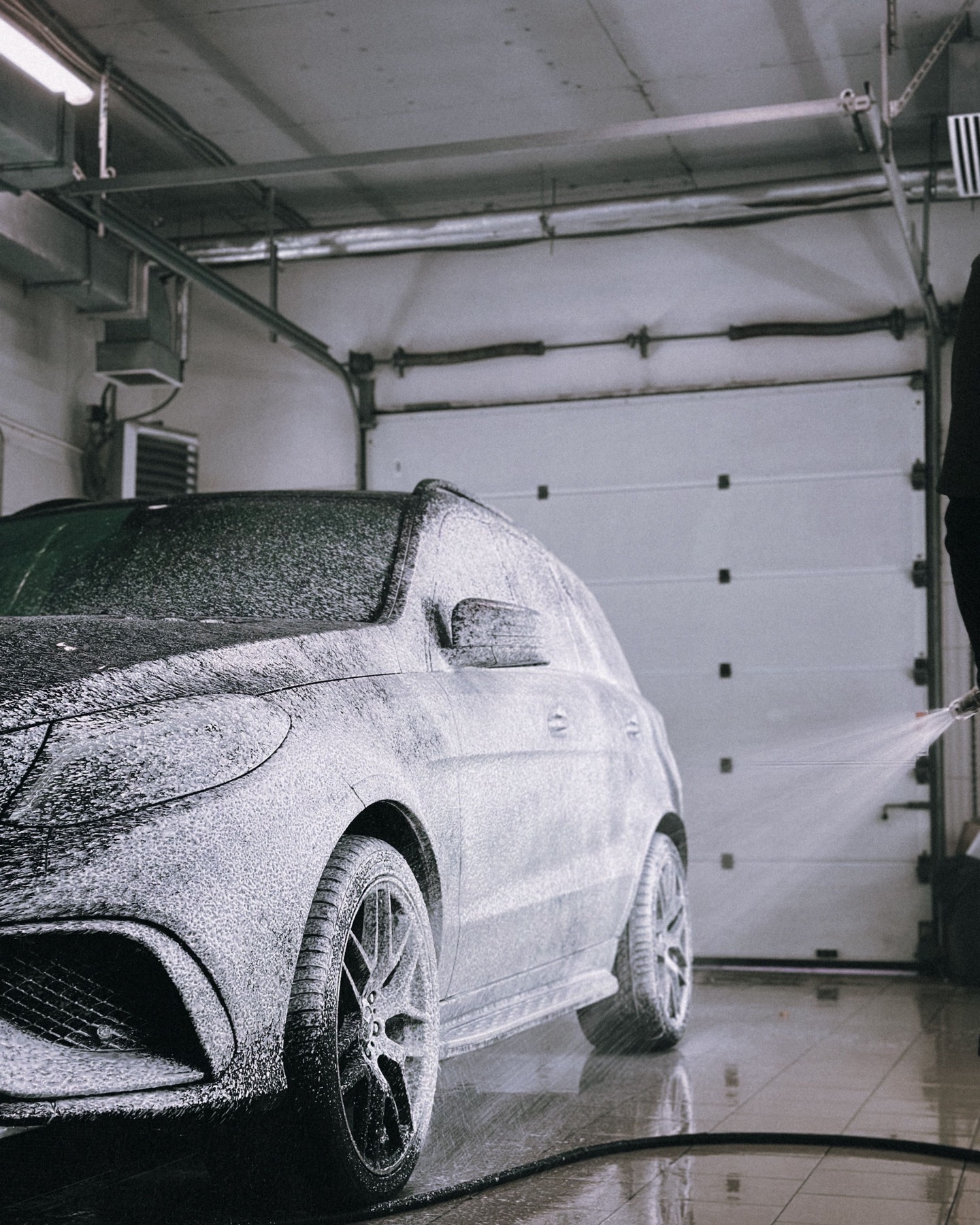 A car under snow foam in the OTEK wash bay