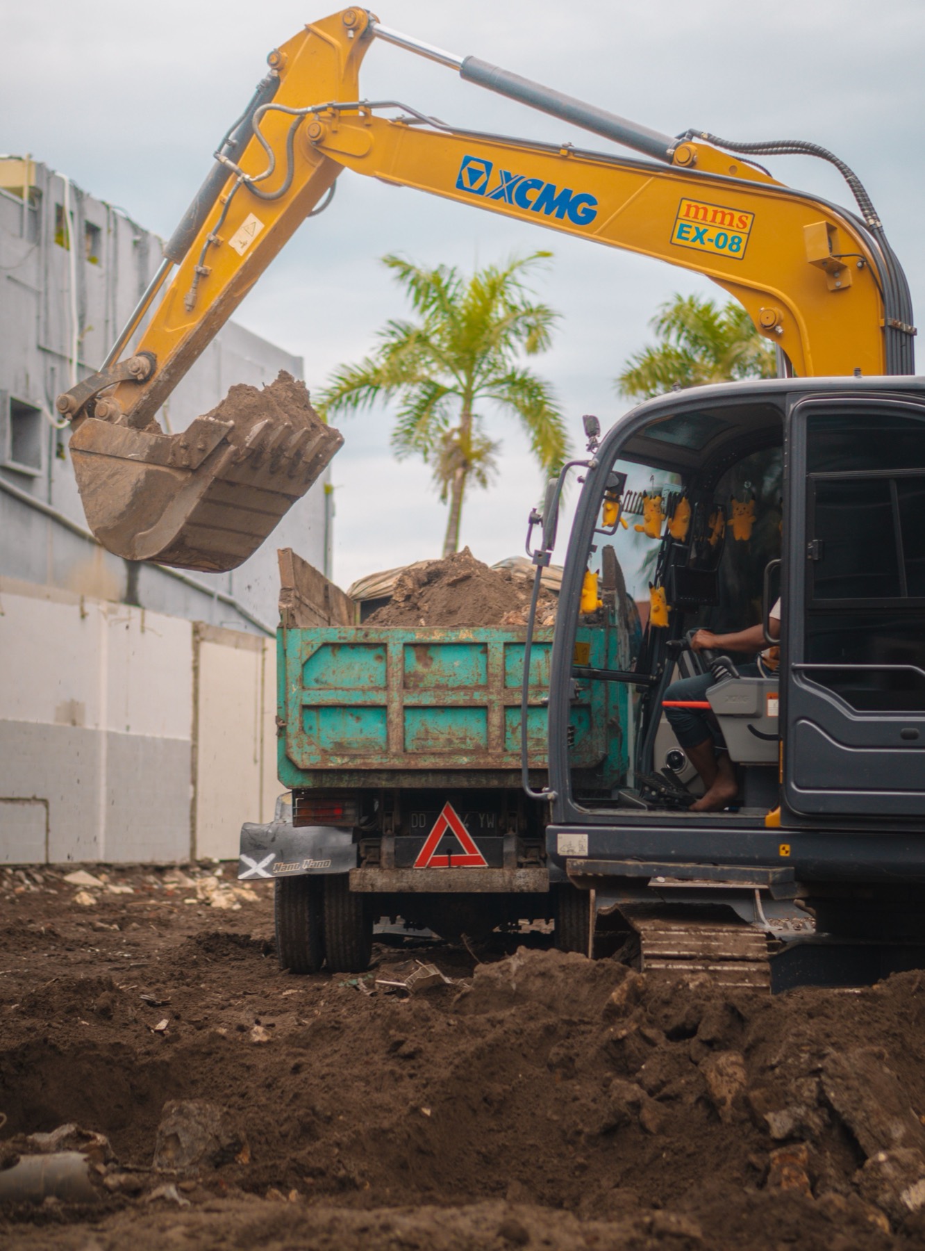 Excavator loading soil into a tiper